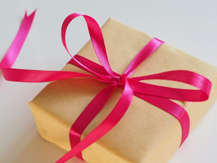 Brown paper wrapped package with pink ribbon